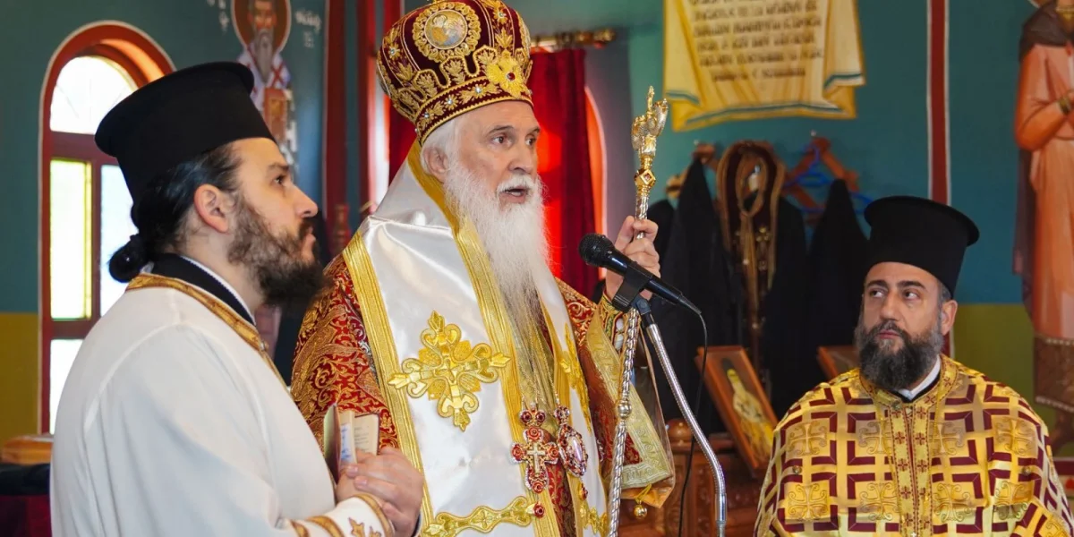 a man in a robe holding a gold object